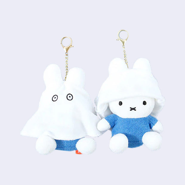 Two of the same plush keychains side by side - Miffy dressed as a ghost with the ghost sheet pulled down and then up on the other figure.