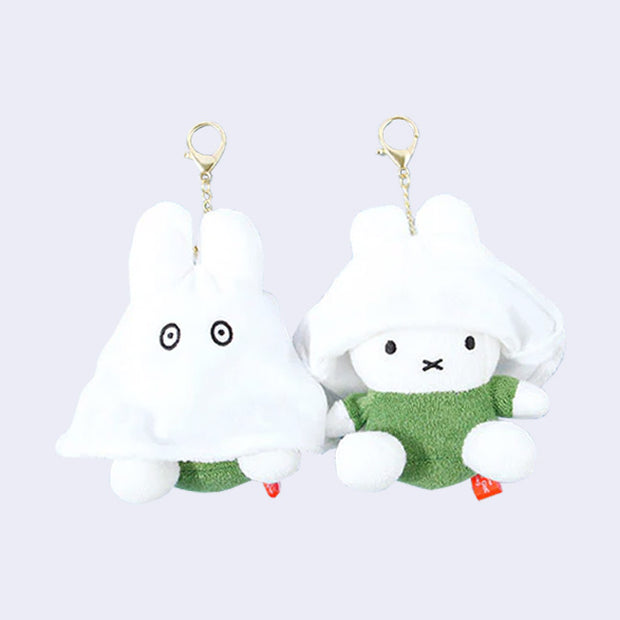 Two of the same plush keychains side by side - Miffy dressed as a ghost with the ghost sheet pulled down and then up on the other figure.