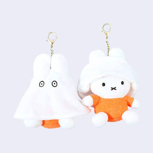 Two of the same plush keychains side by side - Miffy dressed as a ghost with the ghost sheet pulled down and then up on the other figure.