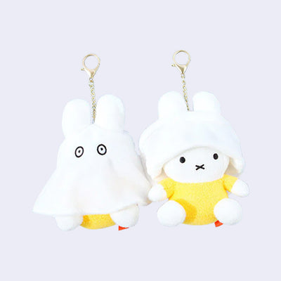 Two of the same plush keychains side by side - Miffy dressed as a ghost with the ghost sheet pulled down and then up on the other figure.
