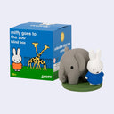 Figurine of an elephant and a rabbit with a 'miffy goes to the zoo' blind box in the background.