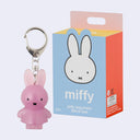 Pink jelly keychain with Miffy branding next to its packaging on a light gray background