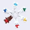 Set of plush keychains of Miffy, wearing different colored shirts and sitting. 