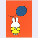 Postcard illustration of Miffy standing, with her hands over her mouth in surprise, as a large blue balloon flies by. Background is orange.