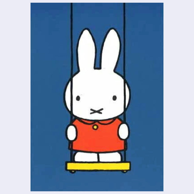 Illustration on blue postcard of Miffy wearing an orange dress and standing up on a swing.