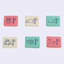 6 flat, rectangular erasers in either pink, green or white. Each eraser has blue text on it that reads "Milan" with a blue line art illustration of an animal.