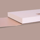 Side view of an open sketchbook with a beige cover and orange elastic band wrapping around it. Text on the front reads "Milan - 1420 The Master Gum"