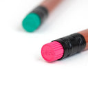 Close up of an eraser on the end of a pencil with "milan" branding.