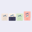 Four square erasers in protective plastic casings of various colors - off white, navy, mint green and pink.