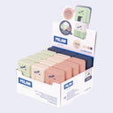 Display box of Milan erasers in various colors on a white background