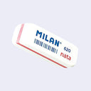 White eraser with slightly angled edges and a pink line going around its exterior. Text on it says "milan 620 nata"