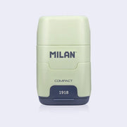 Light green and navy blue plastic case holding an eraser and a pencil sharpener within it, with 'Milan' branding on a light gray background