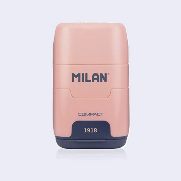 Pink and navy blue plastic case holding an eraser and a pencil sharpener within it, with 'Milan' branding on a light gray background
