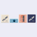 Four pencil sharpeners with Milan branding in white, light blue, pink and navy.