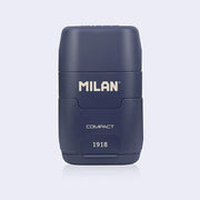 Navy blue plastic case holding an eraser and a pencil sharpener within it, with 'Milan' branding on a light gray background