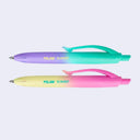 2 small ballpoint click pens with colorful gradient colored bodies and branding on the sides that say "milan sunset"