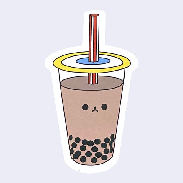 Die cut sticker of a milk tea boba cup with a small smiling cartoon style face in the center of the cup.