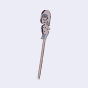 Clear acrylic die cut drink stirrer of a nude cartoon girl, standing with her arms extended behind her back.