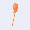 Orange acrylic die cut drink stirrer of a nude cartoon girl, standing with her arms extended behind her back.
