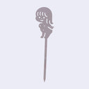 Clear acrylic die cut drink stirrer of a nude cartoon girl, standing with her arms extended behind her back.