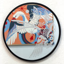 Engraving on a rounded mirror of a bird flying while holding one stalk of grain in its talons. A butterfly flies behind it. The mirror reflects the artwork behind it.