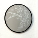 Engraving on a rounded mirror of a bird flying while holding one stalk of grain in its talons. A butterfly flies behind it.