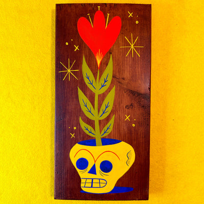 Wooden panel with a retro style painting of a skull vase and red heart flower design on a yellow background
