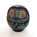 Decorative owl-shaped object with intricate patterns on a white background