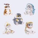 5 small plastic cat figurines, in full body or partial costumes of sea creatures. Options are: otter, shark, penguin, dinosaur and squid.