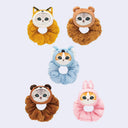 Five animal-themed hair scrunchies on a light gray background