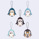 Set of five plush penguin keychains on a light purple background
