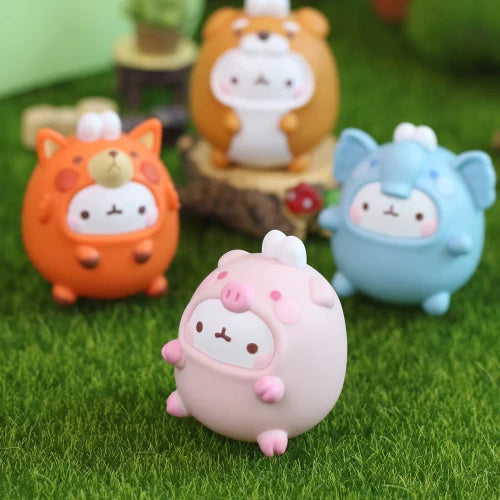 Four colorful animal figurines on a grassy surface