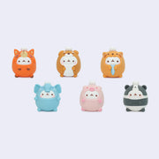 Set of six colorful blind box figures of white bunnies dressed up in animal costumes.