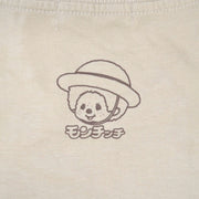 Small logo on the back of a t-shirt of Monchhichi wearing a straw hat and smiling.