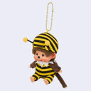Plush keychain of Monchhichi in a bee costume on a light gray background