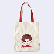 Tote bag with a cartoon monkey, Monchhichi and 'Monchhichi' branding on a light purple background