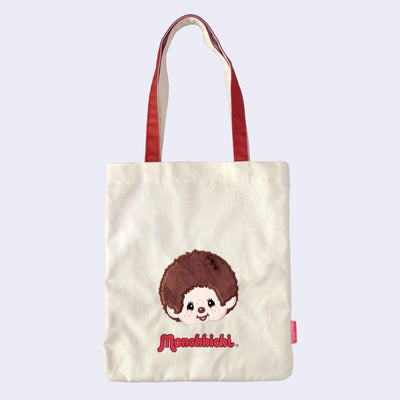 Tote bag with a cartoon monkey, Monchhichi and 'Monchhichi' branding on a light purple background