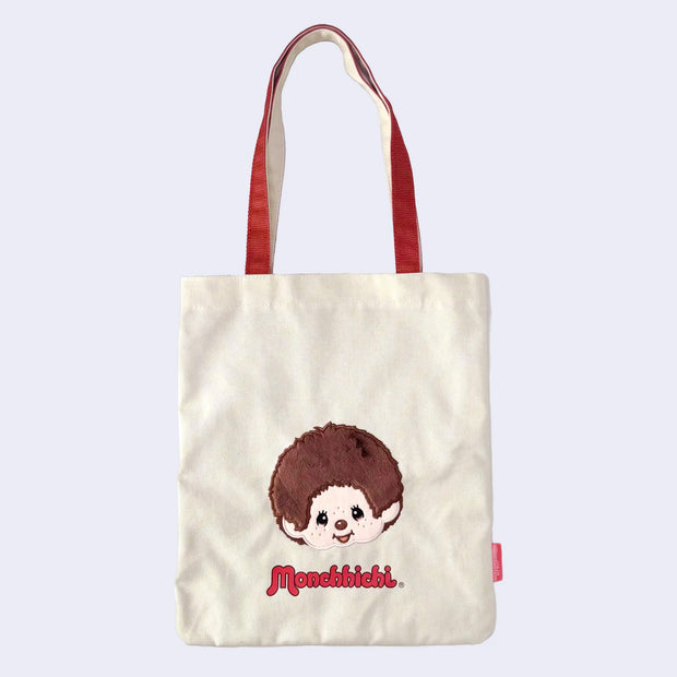 Tote bag with a cartoon monkey, Monchhichi and 'Monchhichi' branding on a light purple background