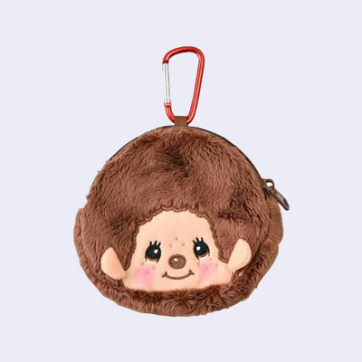 Plush pouch of Monchhichi's smiling head, round, with a red carabiner keychain attached.
