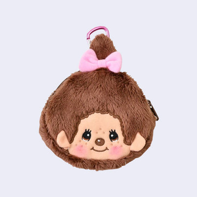 Plush keychain of a smiling Monchhichi girl pouch with a pink bow on a light gray background