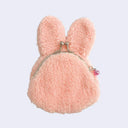 Pink fluffy bunny-shaped coin purse on a light gray background