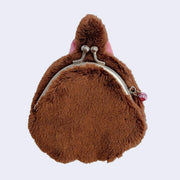 Brown furry coin purse with a metal clasp on a light purple background