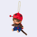 Plush Monchhichi monkey keychain wearing a red ladybug hat and blue overalls on a light gray background