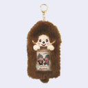 Plush keychain of a Monchhichi character with a clear sleeve in the center, as a place to put a photo. The plush photo holder is attached to a gold hardware keychain.