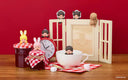 Set of small Monchhichi figures hanging off of various home and kitchen objects.