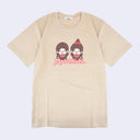 Beige t-shirt with two Monchhichi characters wearing matching red bibs and cheering with their hands up.