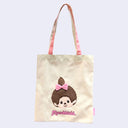 Tote bag with a cartoon Monchhichi girl with a pink bow and 'Monchhichi' branding on a light background