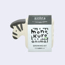 Small off white planter with a semi flat zebra head coming out of one side. It is wrapped in product packaging, which shows what plant seeds are included. (Sweet Basil)