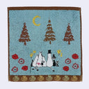 Small hand towel with a graphic of characters from Moomin, facing away from the viewer and sitting together in an outdoor setting under the moon.
