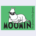 Green book cover featuring Moomin by Tove Jansson & Lars Jansson with a black mask, sitting on a green background above the word 'MOOMIN' in large black letters.